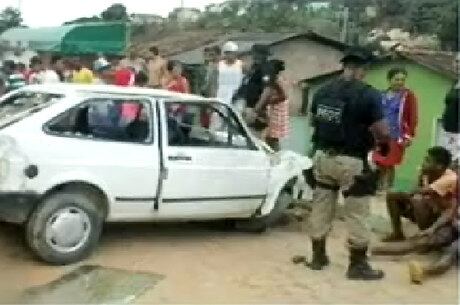 Veículo ficou destruído após capotar; a direita da foto adolescentes que estavam a bordo do carro
