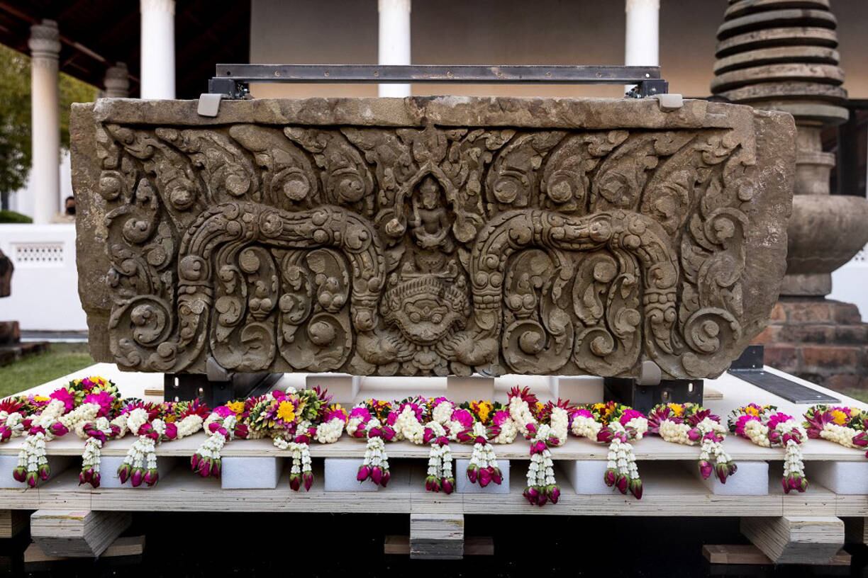 An ancient sandstone lintel, a sacred late 10th or 11th century sandstone support beam, is pictured at the Bangkok National Museum during an event to mark their return from the United States to Thailand, in Bangkok on May 31, 2021.
Jack TAYLOR / AFP
