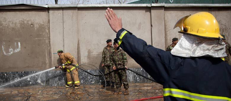 Militares afegãos limpam o muro do Ministério da Defesa, onde aconteceu o atentado