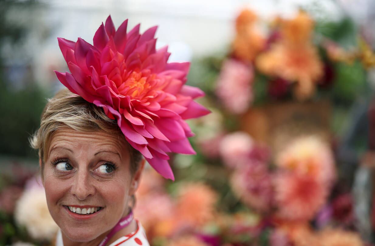 A person wearing a floral headpiece poses while attending the final day of the Chelsea Flower Show, delayed from its usual spring dates because of the lockdown restrictions amid the spread of the coronavirus disease (COVID-19) pandemic in London, Britain, September 26, 2021. REUTERS/Henry Nicholls