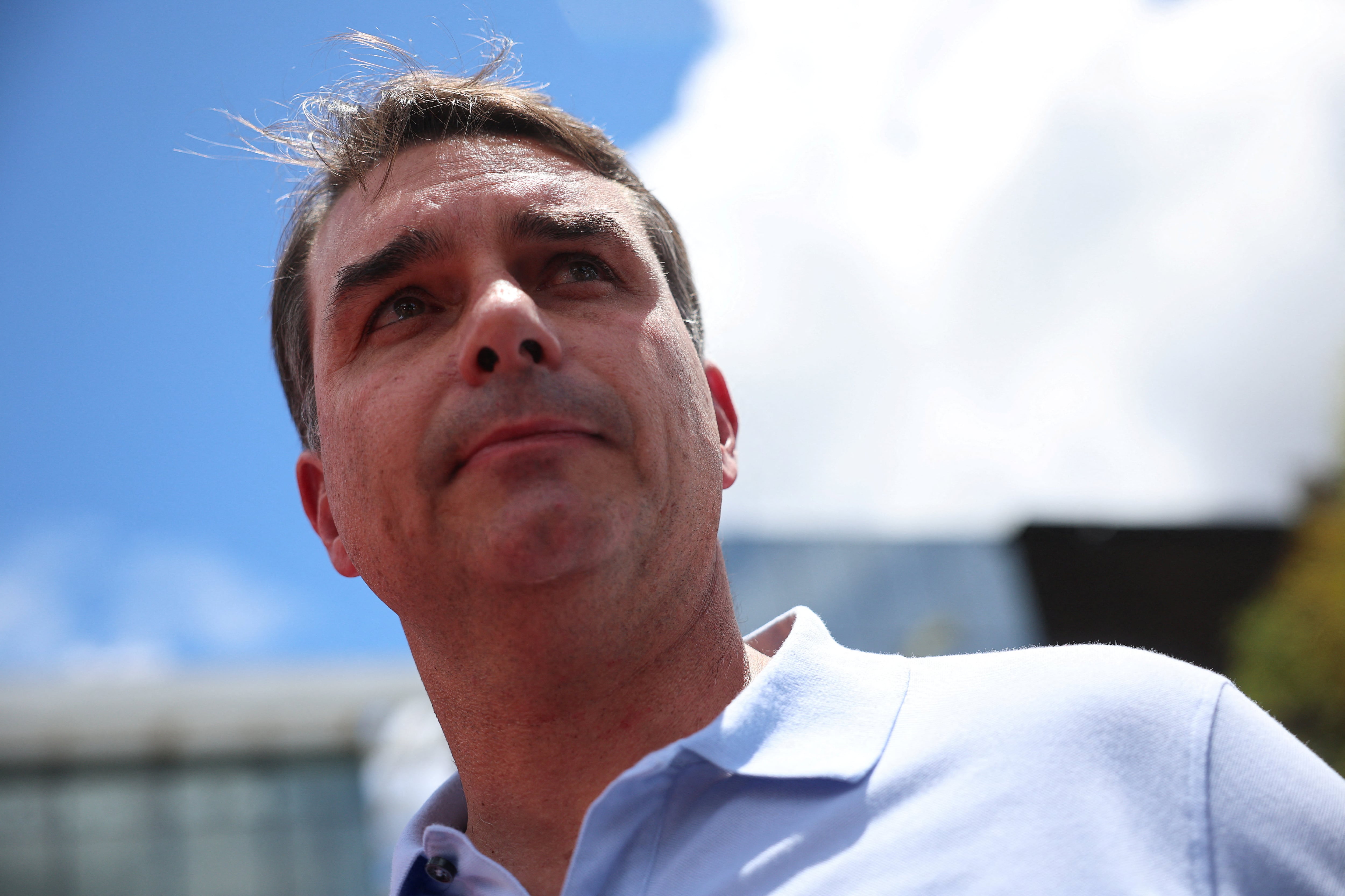 Senator Flavio Bolsonaro attends a press conference outside a hospital, as his father, Brazil's former President Jair Bolsonaro is hospitalized, while serving a 27-year sentence for plotting a coup against his successor, President Luiz Inacio Lula da Silva, in Brasilia, Brazil, March 13, 2026. REUTERS/Adriano Machado