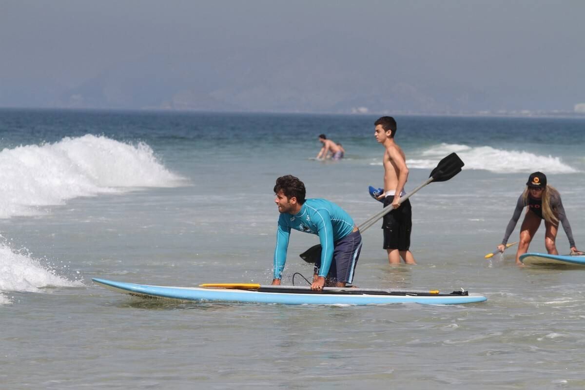 Bruno Gagliasso e Ricardo Pereira praticam stand up paddle na praia da Barra da Tijuca, no Rio