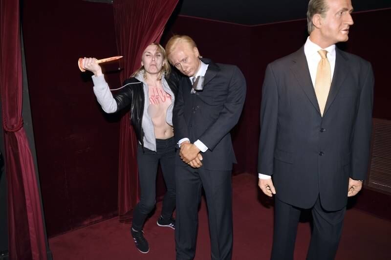 Ativista do Femen esfaqueia uma estátua de cera do presidente russo Vladimir Putin para denunciar o governo russo