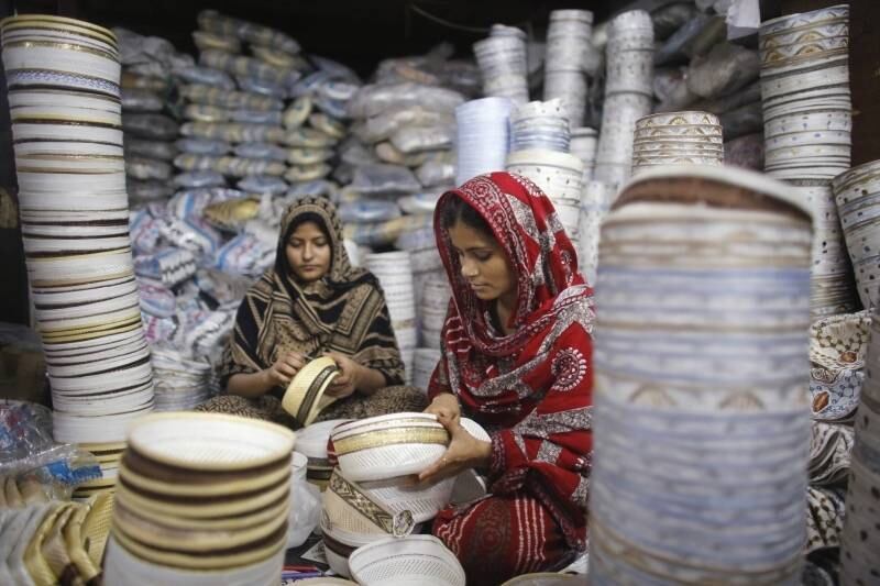 Trabalhadoras de fábrica
em Daca, Bangladesh, costuram chapéus islâmicos utilizados em orações. A
demanda por tais itens está muito alta devido ao mês do Ramadã