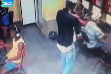 Suspeito se aproxima de jovem com uma arma e frequentadores não percebem a ação em LAN house de São João de Meriti