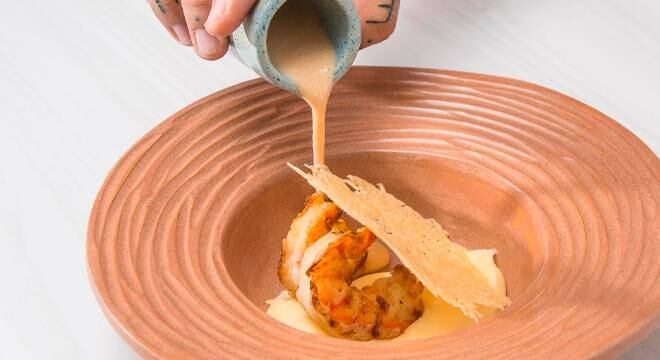 O chef Matheus Emerick ensina como fazer camarão grelhado com aligot de batata com queijo canastra e bisque com leite de coco