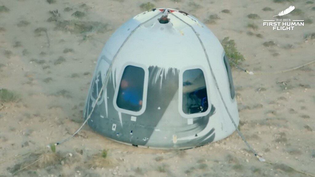 US-space-TOURISM-BlueOrigin
This still image taken from video by Blue Origin shows Blue Origin's reusable New Shepard craft capsule as it returns from space after it safely landed, on July 20, 2021, in Van Horn, Texas. Blue Origin's first crewed mission is an 11-minute flight from west Texas to an altitude of 65 miles (106kms), and back again, to coincide with the 52nd anniversary of the first Moon landing.
Handout / BLUE ORIGIN / AFP