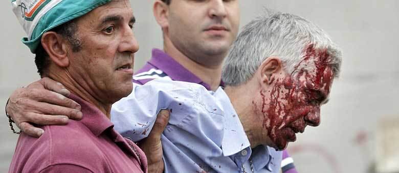 Dois homens ajudam o condutor Francisco José Garzón a sair da área próxima ao acidente de trem