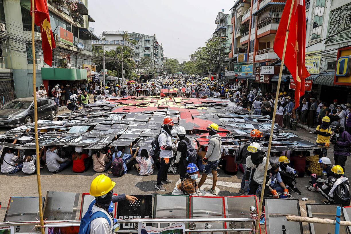 (Myanmar), 12/03/2021.- Demonstrators hold placards during a protest against the military coup in Yangon, Myanmar, 12 March 2021. The United Nations (UN) Security Council condemned the violence against peaceful demonstrators and called for the Myanmar military to show restraint in a statement on 10 March. Anti-coup protests continue in Myanmar amid intensifying violent crackdowns on demonstrators by security forces. (Protestas, Golpe de Estado, Birmania) EFE/EPA/STRINGER