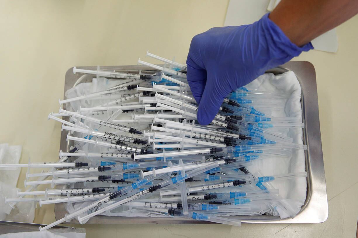 Medical staff holds a dose of the Pfizer-BioNTech vaccine against the coronavirus disease (COVID-19) during a program without an appointment in Sant Vicenc de Casteller, north of Barcelona, Spain, July 6, 2021. REUTERS/ Albert Gea