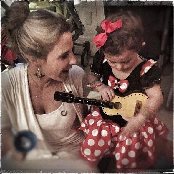 Um pouco maiorzinha, Minna ganhou da mãe um pequeno violão. Com seus pequenos dedinhos, ela experimentou tirar alguns acordes do brinquedo