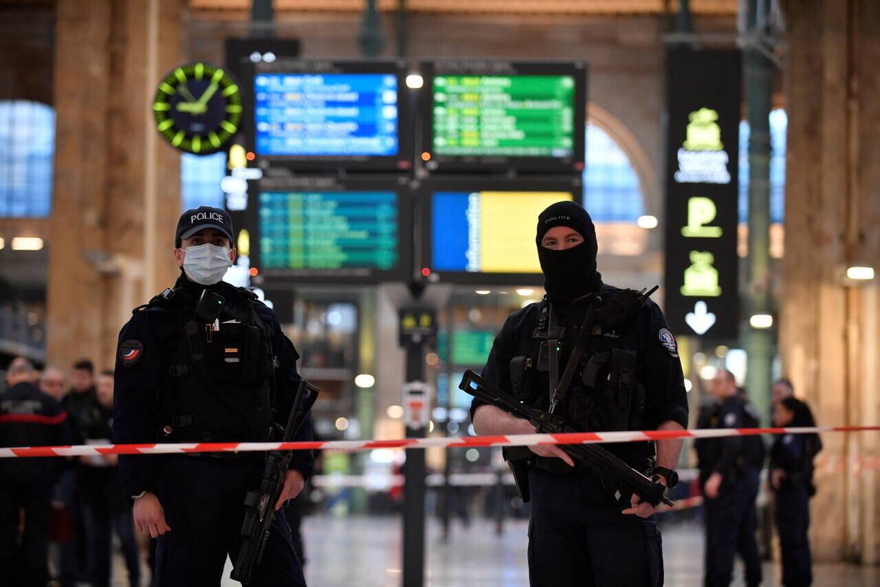 French police stand guard in a cordonned off area at Paris' Gare du Nord train station, after several people were lightly wounded by a man wielding a knife on January 11, 2023. The man was arrested by police at the station, which serves as a hub for trains to London and northern Europe, after they opened fire and wounded him, said a police source, who asked not to be named.
