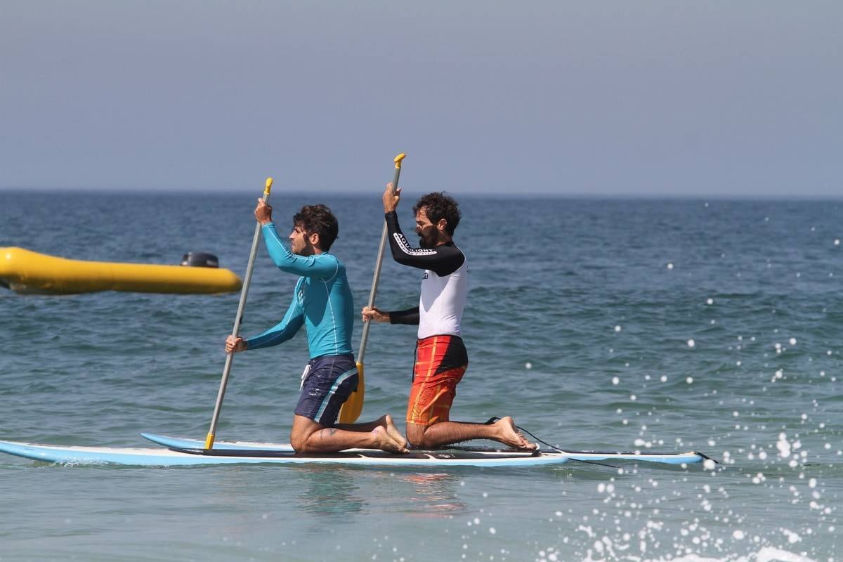 Bruno Gagliasso e Ricardo Pereira praticam stand up paddle na praia da Barra da Tijuca, no Rio