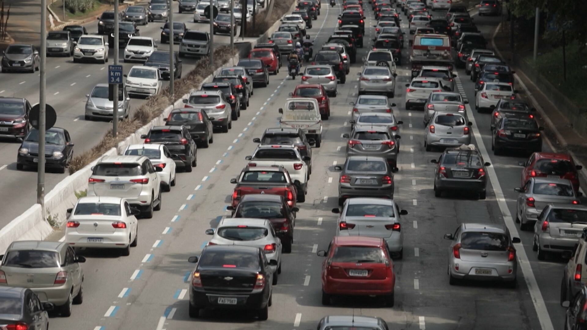 Trânsito intenso em rodovia com múltiplas faixas e muitos carros congestionados
