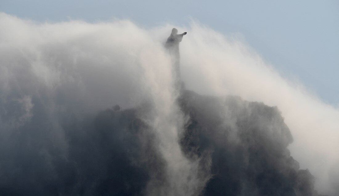 Rio De Janeiro (Brazil).- Grey clouds partially cover the Christ the Redeemer statue as seen from the Rio 2016 Olympic Games Rowing events at the Lagoa Rodrigo de Freitas in Rio de Janeiro, Brazil, 09 August 2016 (reissued 21 May 2020). Considered to be a neutral and unemotional color, grey is most commonly associated with architecture, smoke, and grey-clouded sky. In psychology, grey symbolizes intellect, knowledge and wisdom but is also associated with old age and loss or depression. It can appear conservative and boring on one hand and calming and sophisticated on the other. With its many shades, grey is the color of compromise - neither black nor white. (Brasil) EFE/EPA/FRANCK ROBICHON ATTENTION: This Image is part of a PHOTO SET *** Local Caption *** 52938153