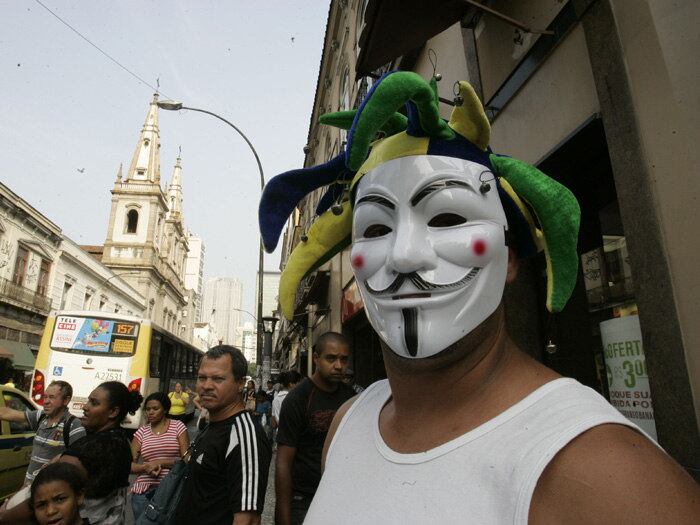 A máscara do personagem V, do filme V de Vingança, virou marca registrada dos protestos que ganham as ruas do Brasil a cada dia e brigam, em geral, pela melhor administração do dinheiro público. Símbolo do anonimato em manifestos ao redor do mundo, o rosto de cavanhaque desenhado e sorriso debochado deu cara também ao movimento brasileiro e, na carona, alavancou o faturamento da fábrica que produz as peças no Rio de Janeiro