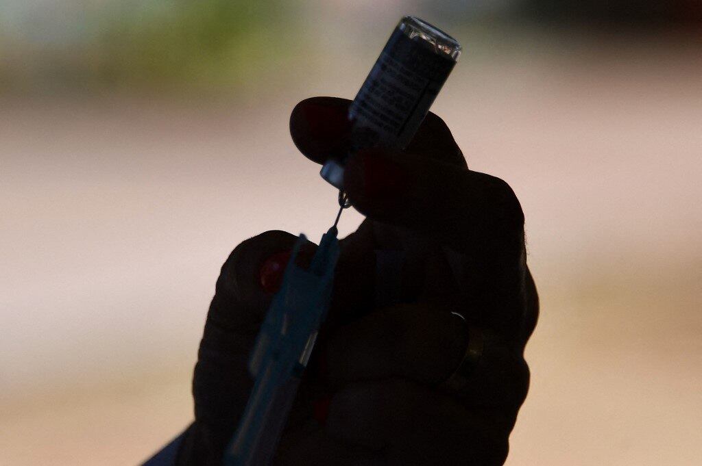 A healthcare worker prepares a dose of the AstraZeneca/Oxford COVID-19 vaccine at a drive-thru vaccination post in Brasilia on September 13, 2021. Brazil is one of the fastest vaccinating countries on the planet, after a late and chaotic start that continues to take its toll on President Jair Bolsonaro.
EVARISTO SA / AFP